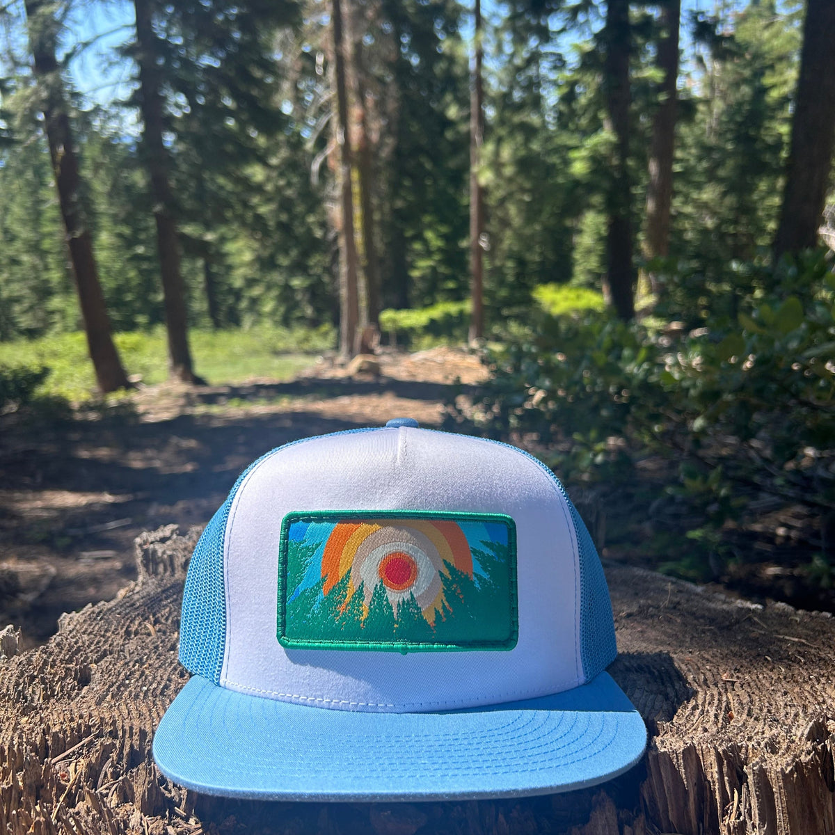 Columbia blue and white Kooh Culture flat brim trucker hat with the In the Trees XL patch