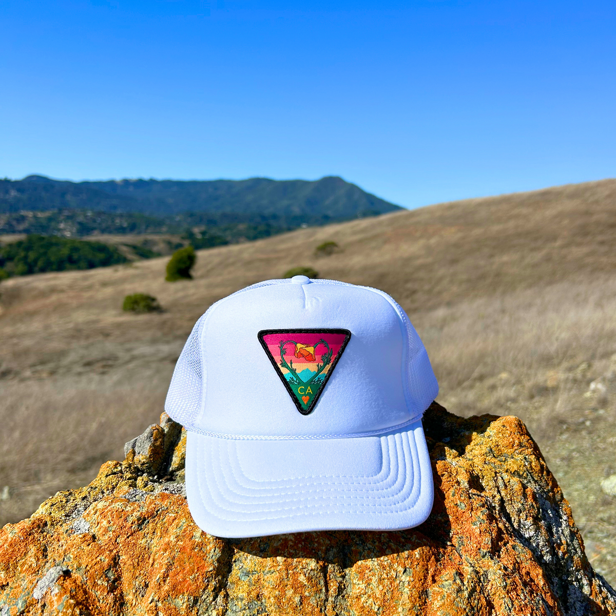 White Kooh Culture foam trucker hat with the Poppy CA Love patch