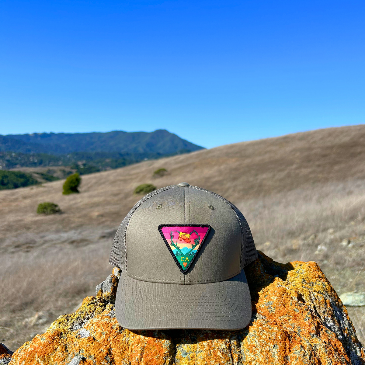 Olive Kooh Culture trucker hat with the Poppy CA Love patch