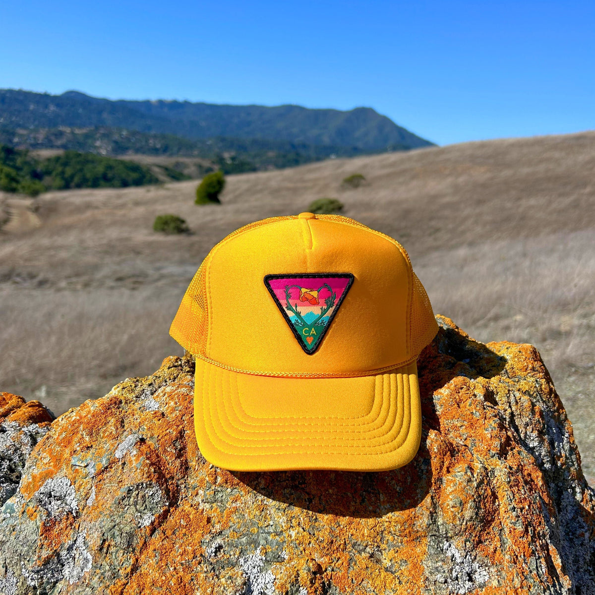 Gold Kooh Culture foam trucker hat with the Poppy CA Love patch