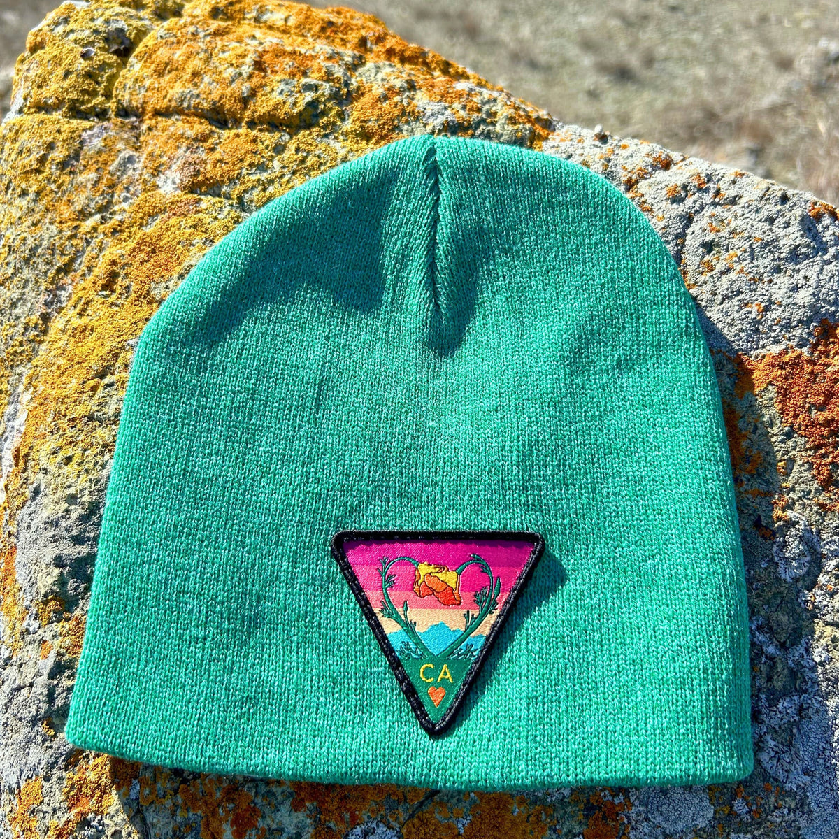Heather green Kooh Culture cuffed beanie with the Poppy CA Love patch