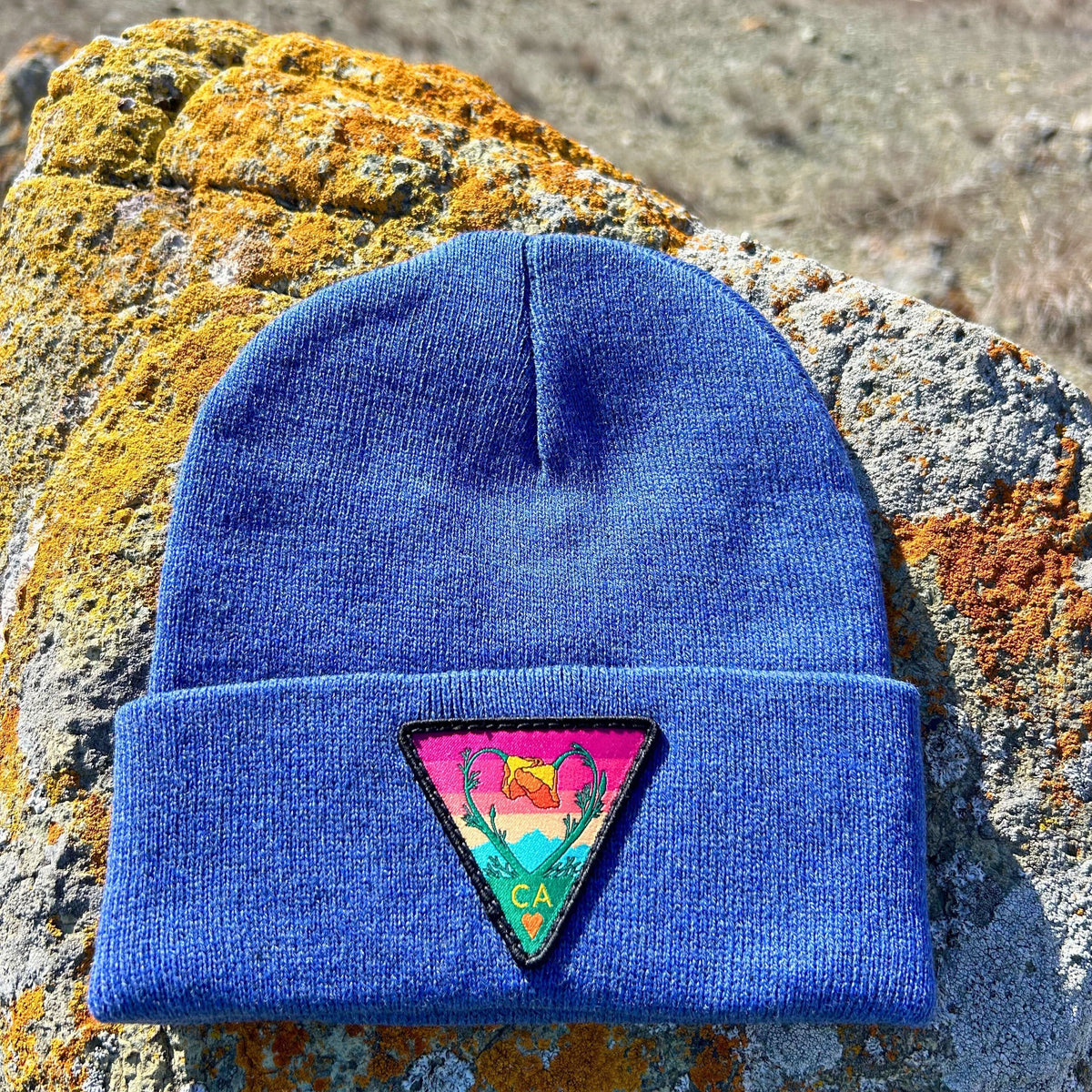 Heather blue Kooh Culture cuffed beanie with the Poppy CA Love patch