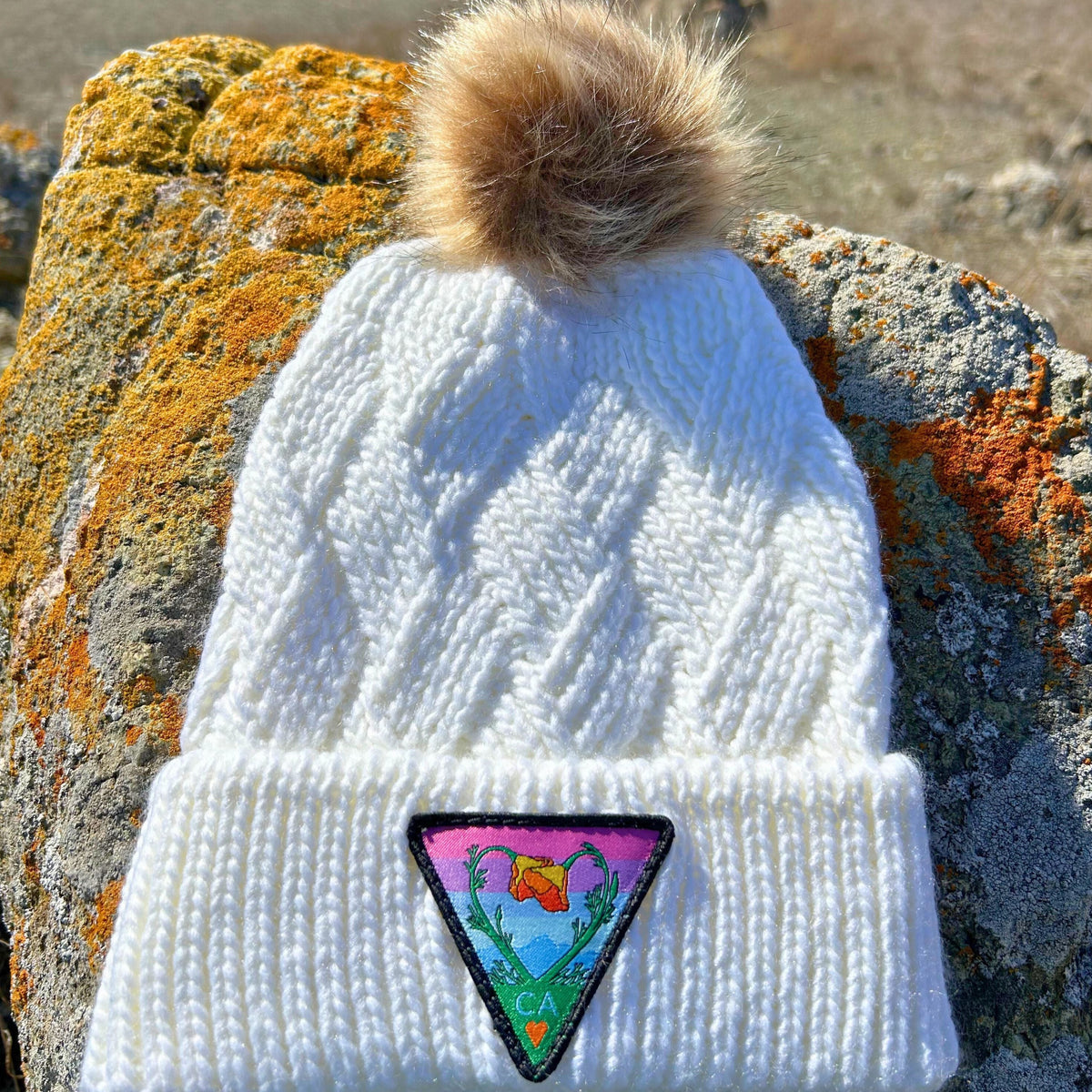 White Kooh Culture faux fur pom beanie with the Poppy CA Love patch
