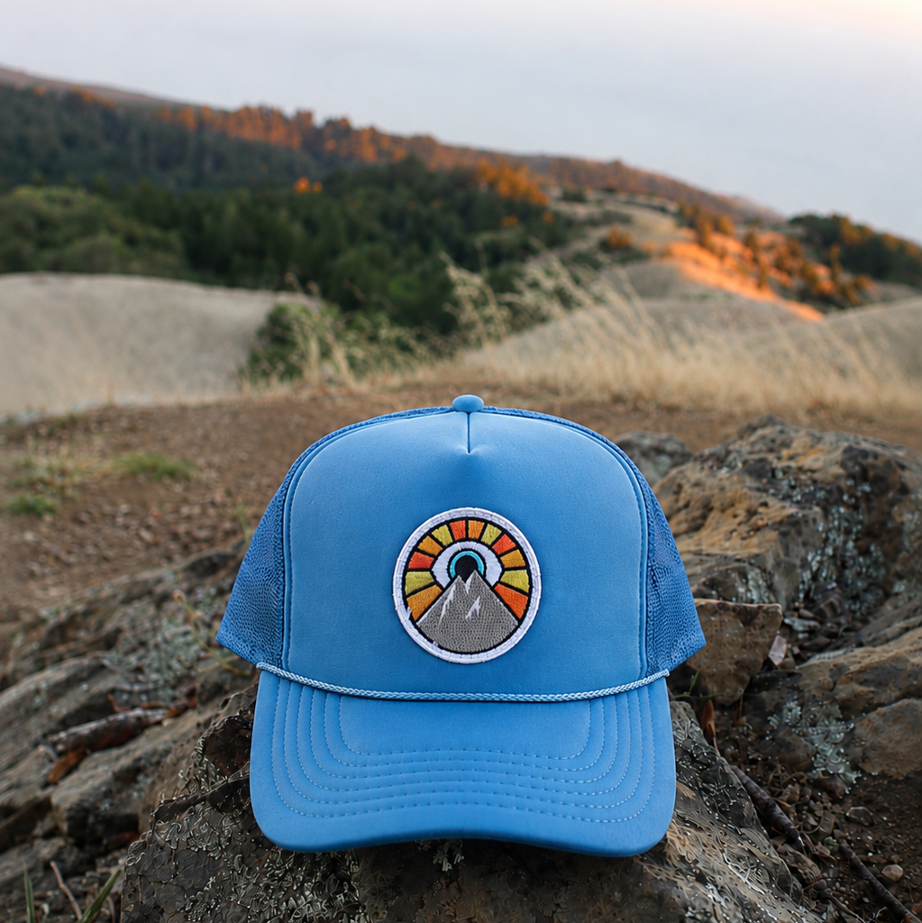 Neon blue Kooh Culture foam trucker hat with the Evil Eye Sun patch