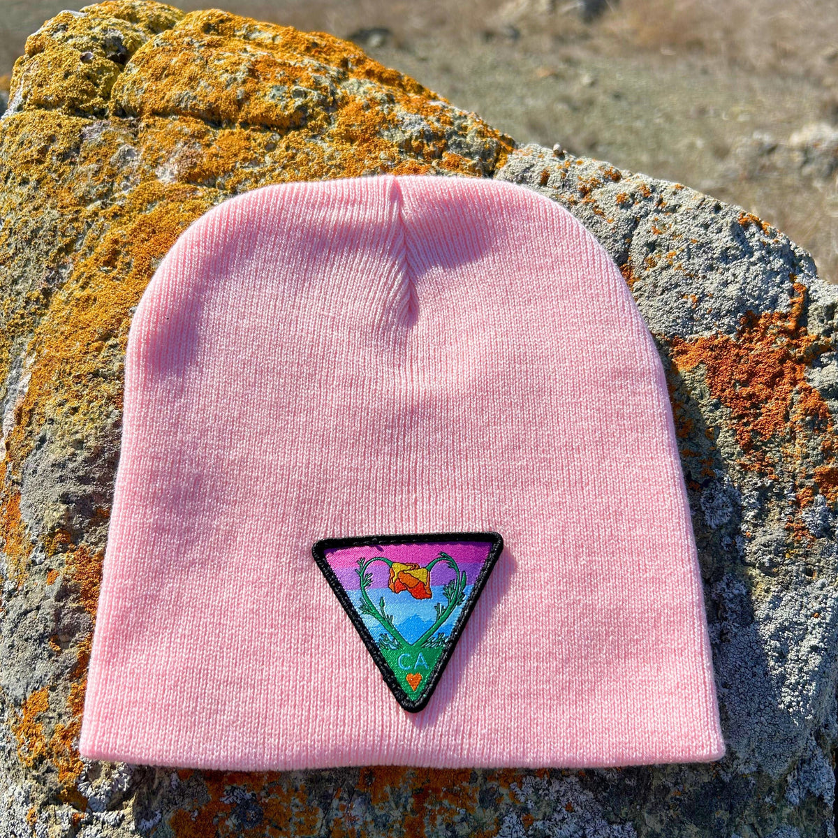 Light pink Kooh Culture cuffed beanie with the Poppy CA Love patch