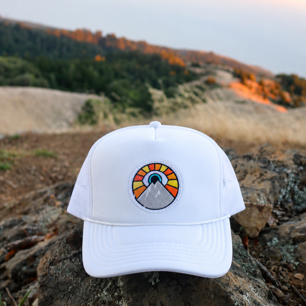 White Kooh Culture foam trucker hat with the Evil Eye Sun patch