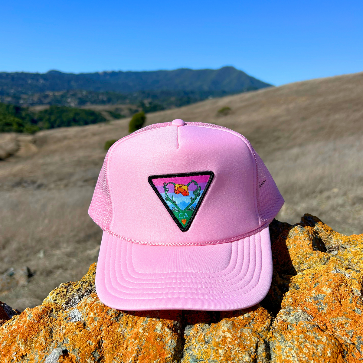 Light pink Kooh Culture foam trucker hat with the Poppy CA Love patch