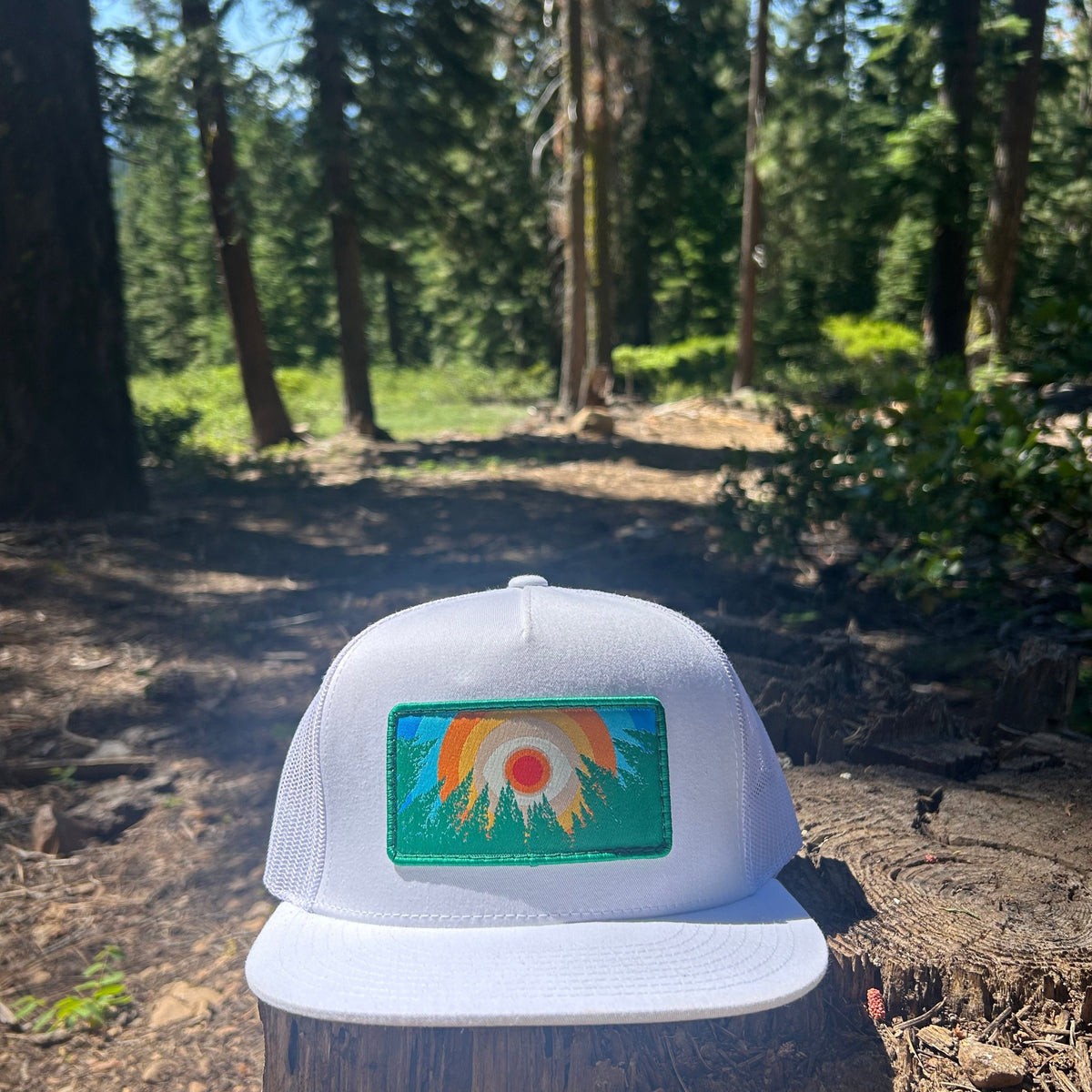 White Kooh Culture flat brim trucker hat with the In the Trees XL patch