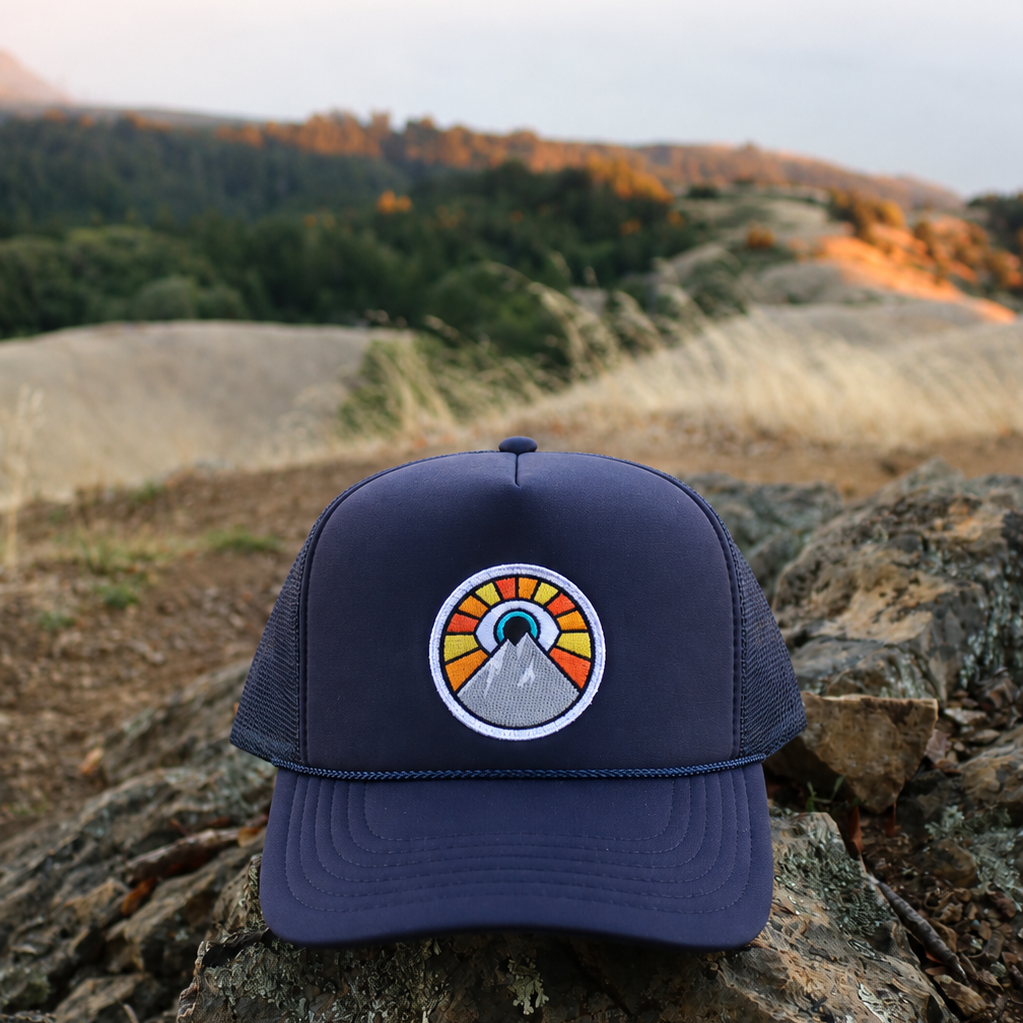 Navy Kooh Culture foam trucker hat with the Evil Eye Sun patch