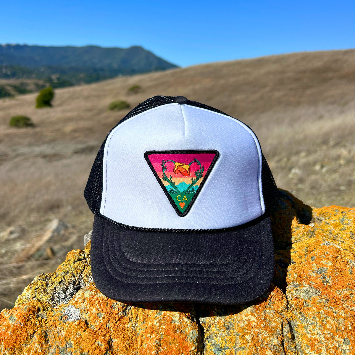 White and black Kooh Culture youth foam trucker hat with the Poppy CA Love patch