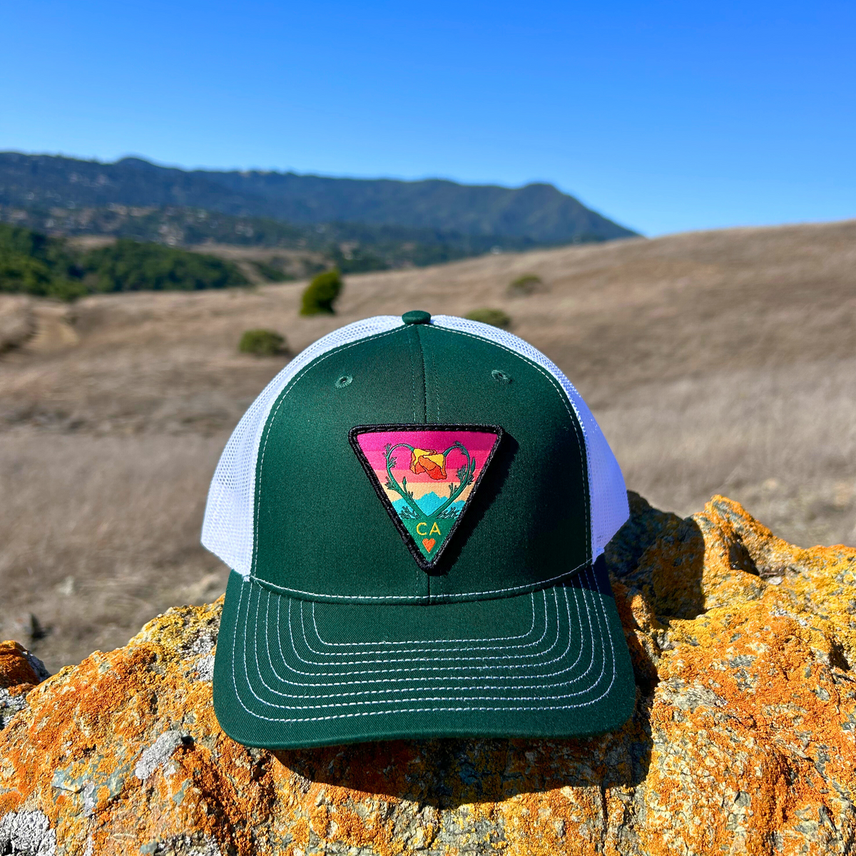 Dark green and white Kooh Culture trucker hat with the Poppy CA Love patch