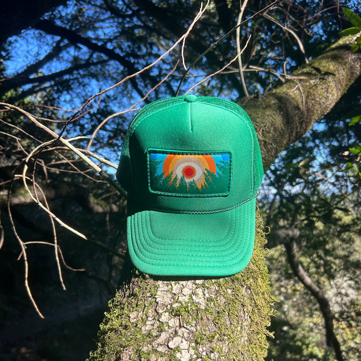 Kelly green Kooh Culture foam trucker hat with the In the Trees XL patch