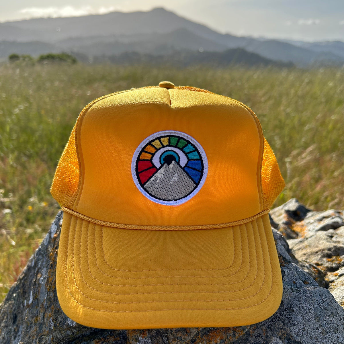 Gold Kooh Culture foam trucker hat with the Evil Eye Sun patch in Rainbow Edition colours
