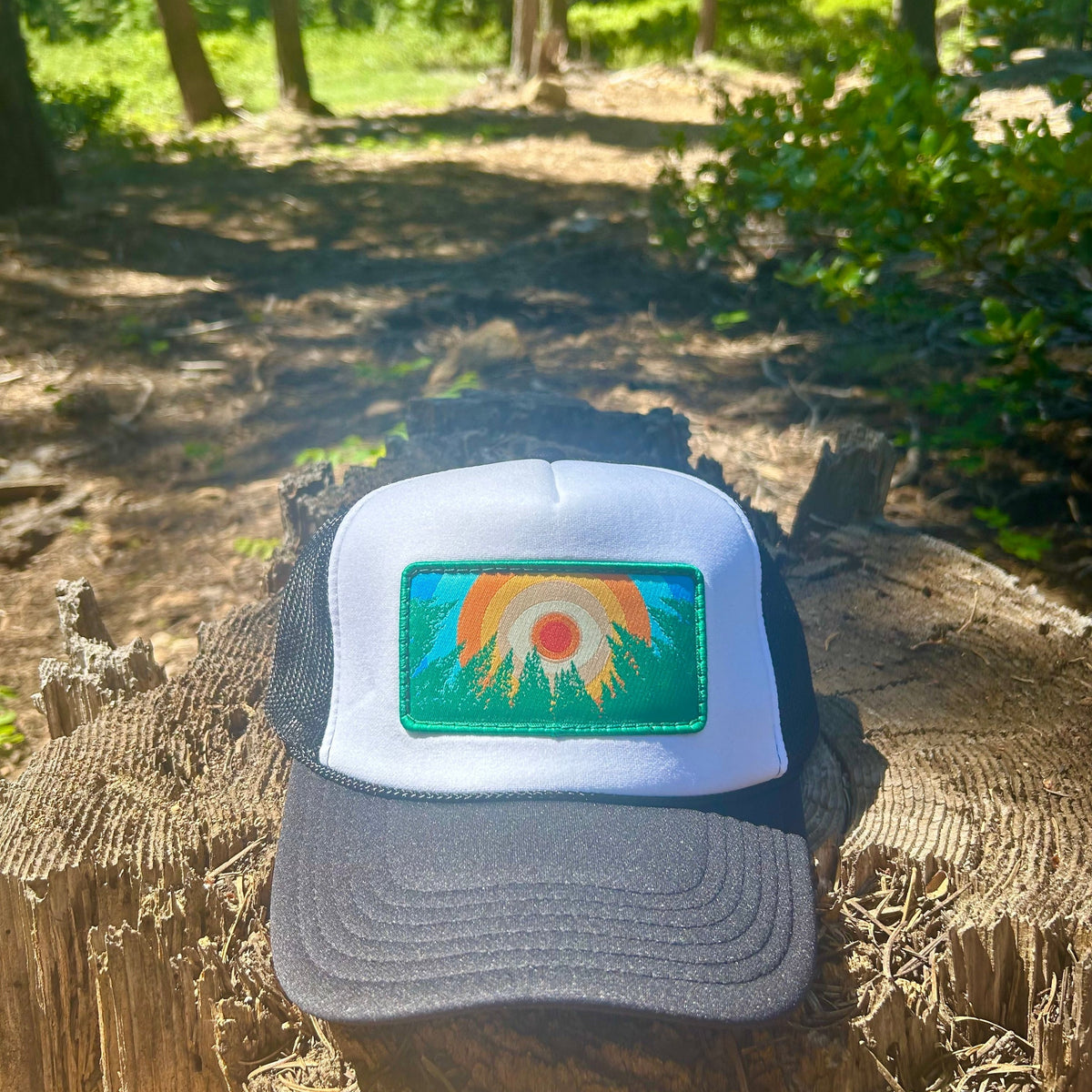 Black and white Kooh Culture foam trucker hat with the In the Trees XL patch