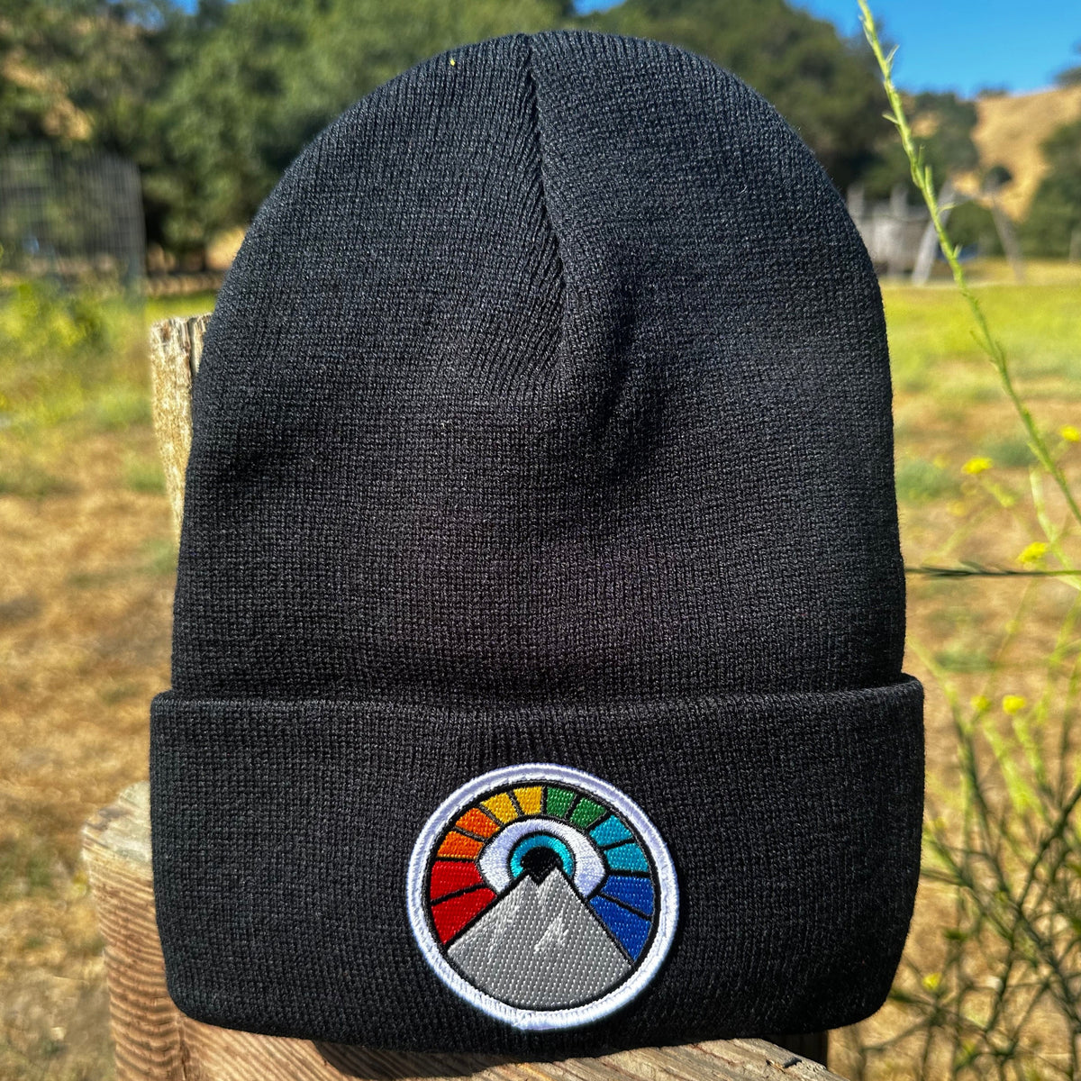 Black Kooh Culture cuffed beanie with the Evil Eye Sun patch in Rainbow Edition colours