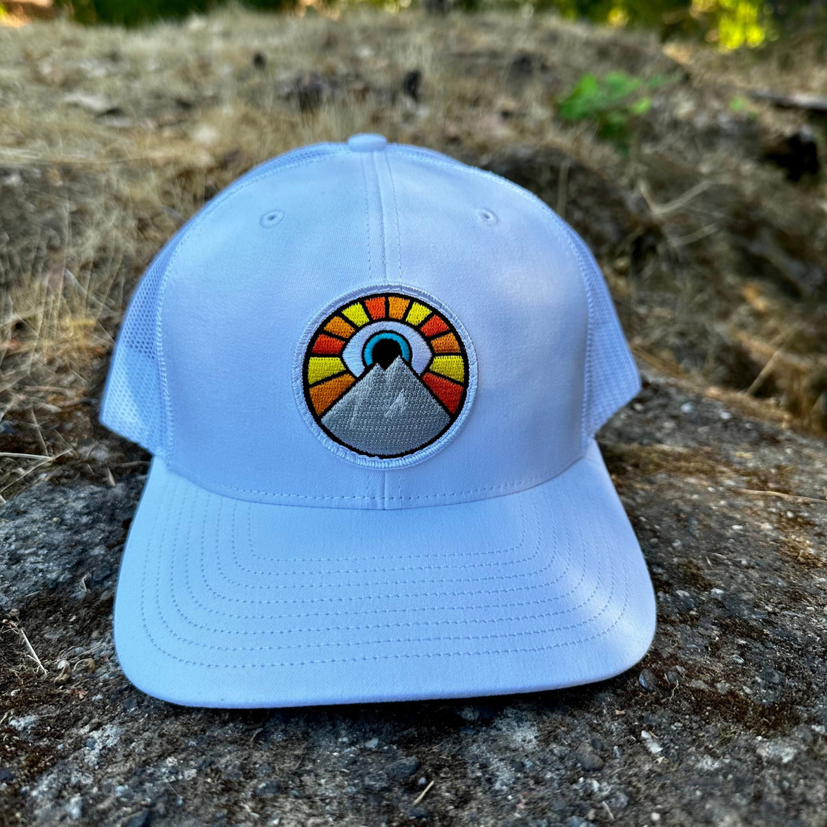 White Kooh Culture trucker hat with the Evil Eye Sun patch
