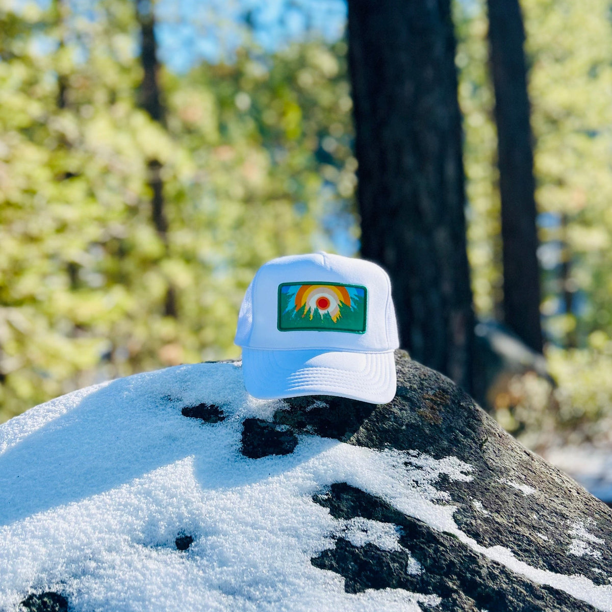 White Kooh Culture foam trucker hat with the In the Trees XL patch