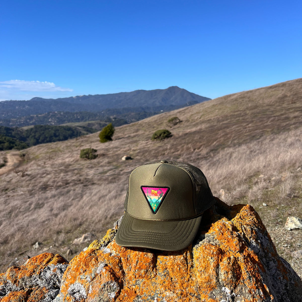 Olive green Kooh Culture foam trucker hat with the Poppy CA Love patch, alternate view