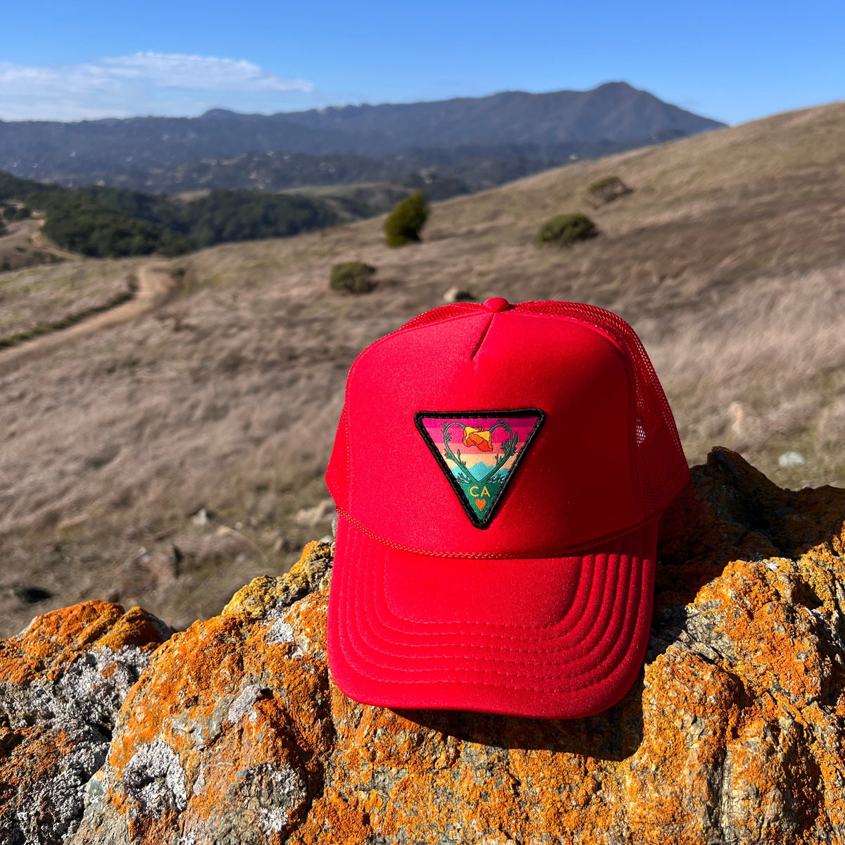 Red Kooh Culture foam trucker hat with the Poppy CA Love patch