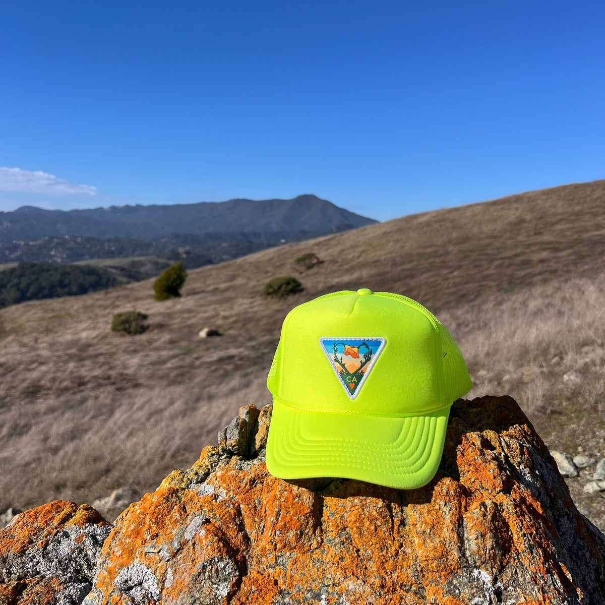 Neon yellow Kooh Culture foam trucker hat with the Poppy CA Love patch, alternate view