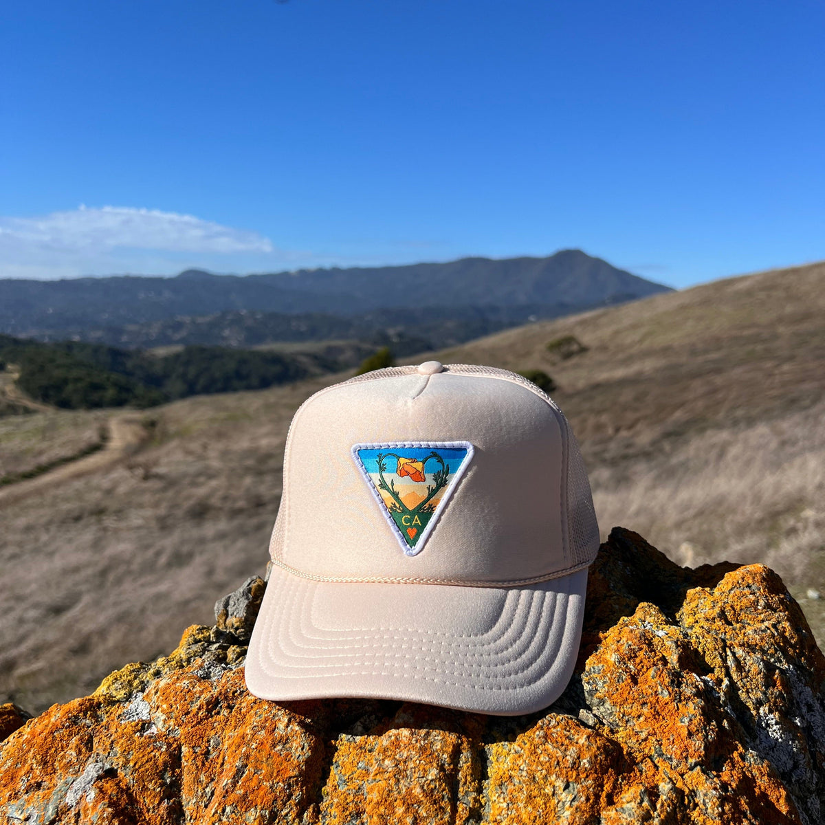 Tan Kooh Culture foam trucker hat with the Poppy CA Love patch