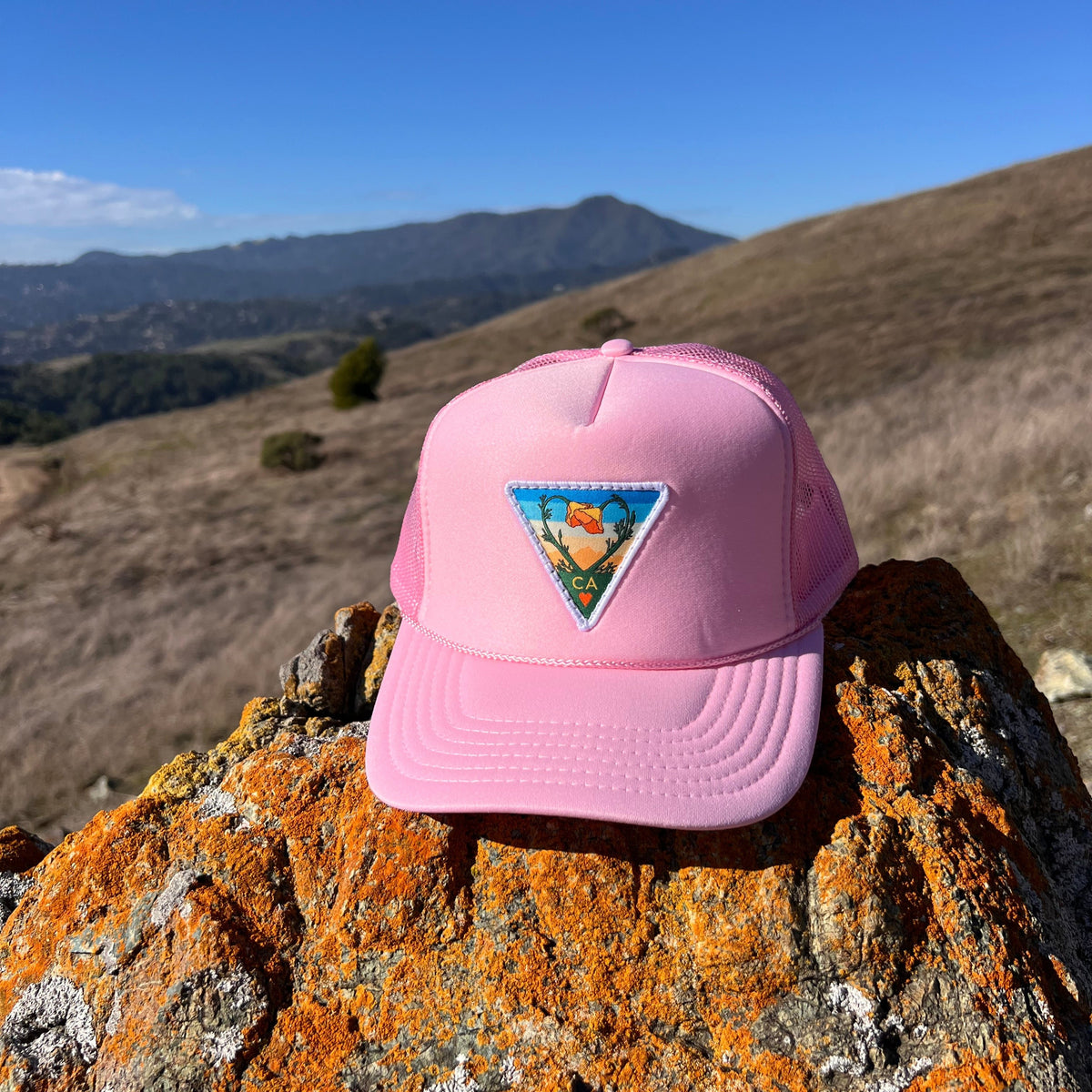 Soft pink Kooh Culture foam trucker hat with the Poppy CA Love patch
