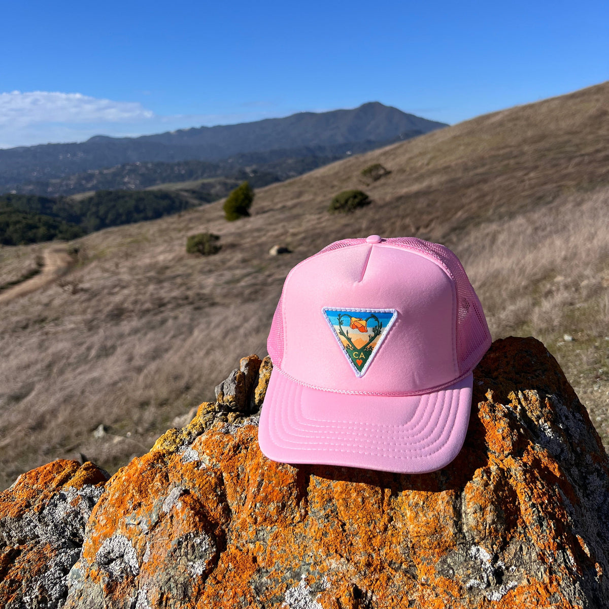 Soft pink Kooh Culture foam trucker hat with the Poppy CA Love patch, alternate view