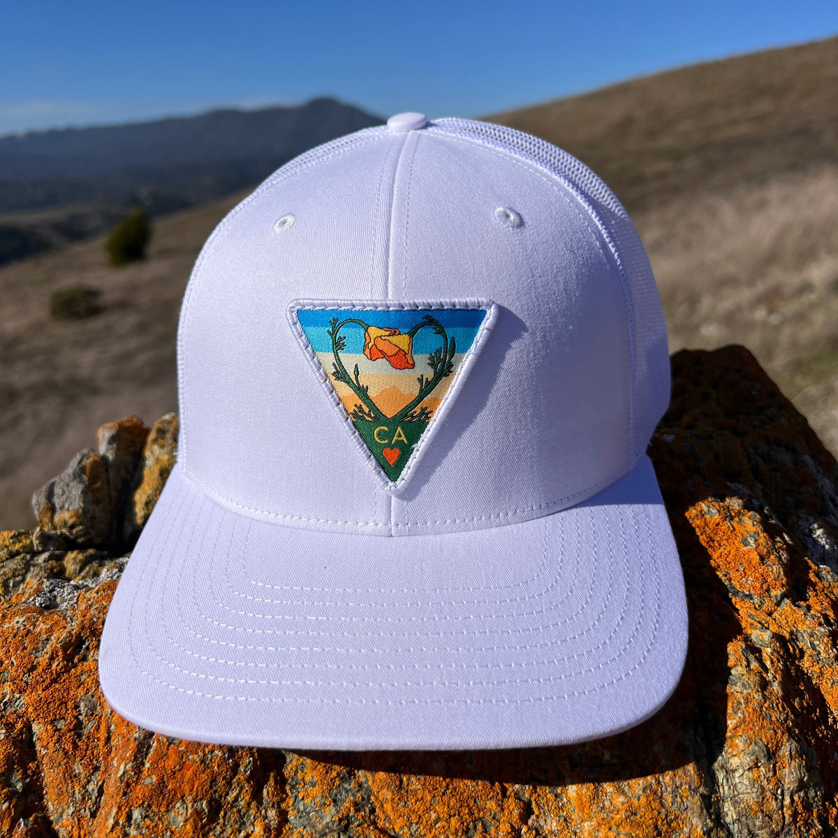 White Kooh Culture trucker hat with the Poppy CA Love patch