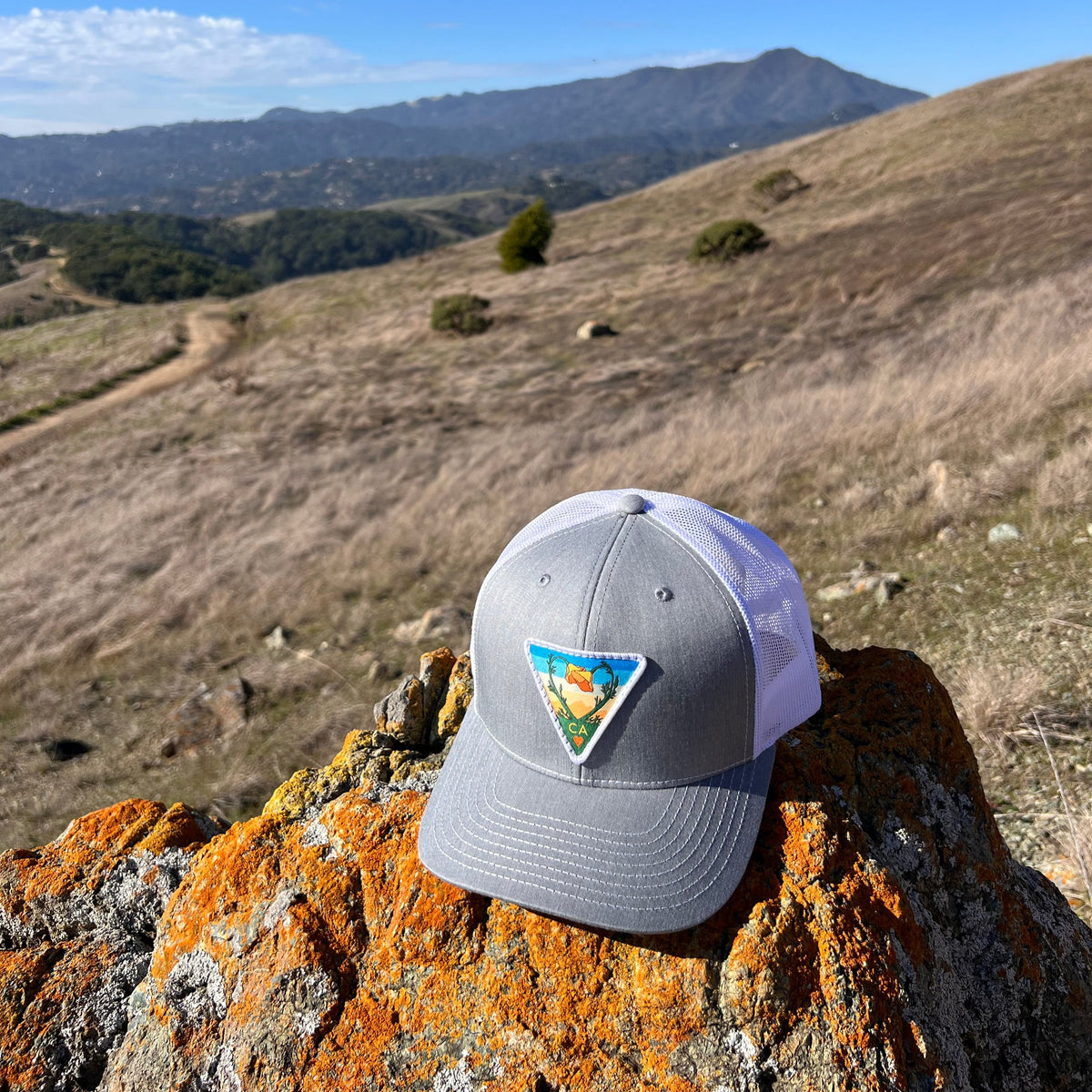 Heather grey and white Kooh Culture trucker hat with the Poppy CA Love patch, alternate view