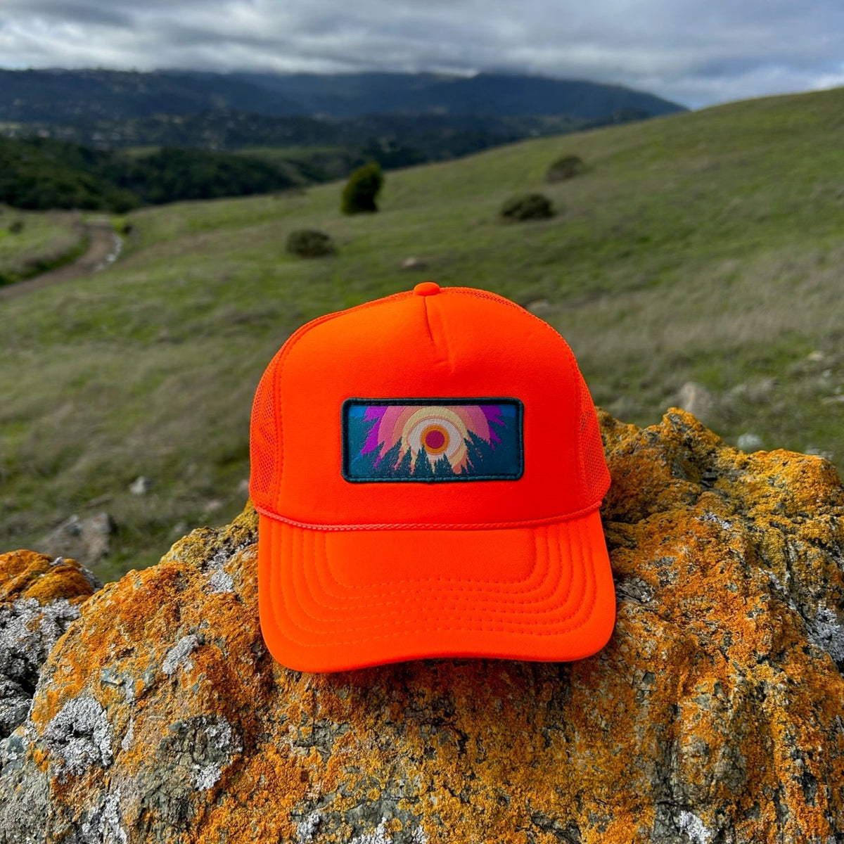 Neon orange Kooh Culture foam trucker hat with the In the Trees patch
