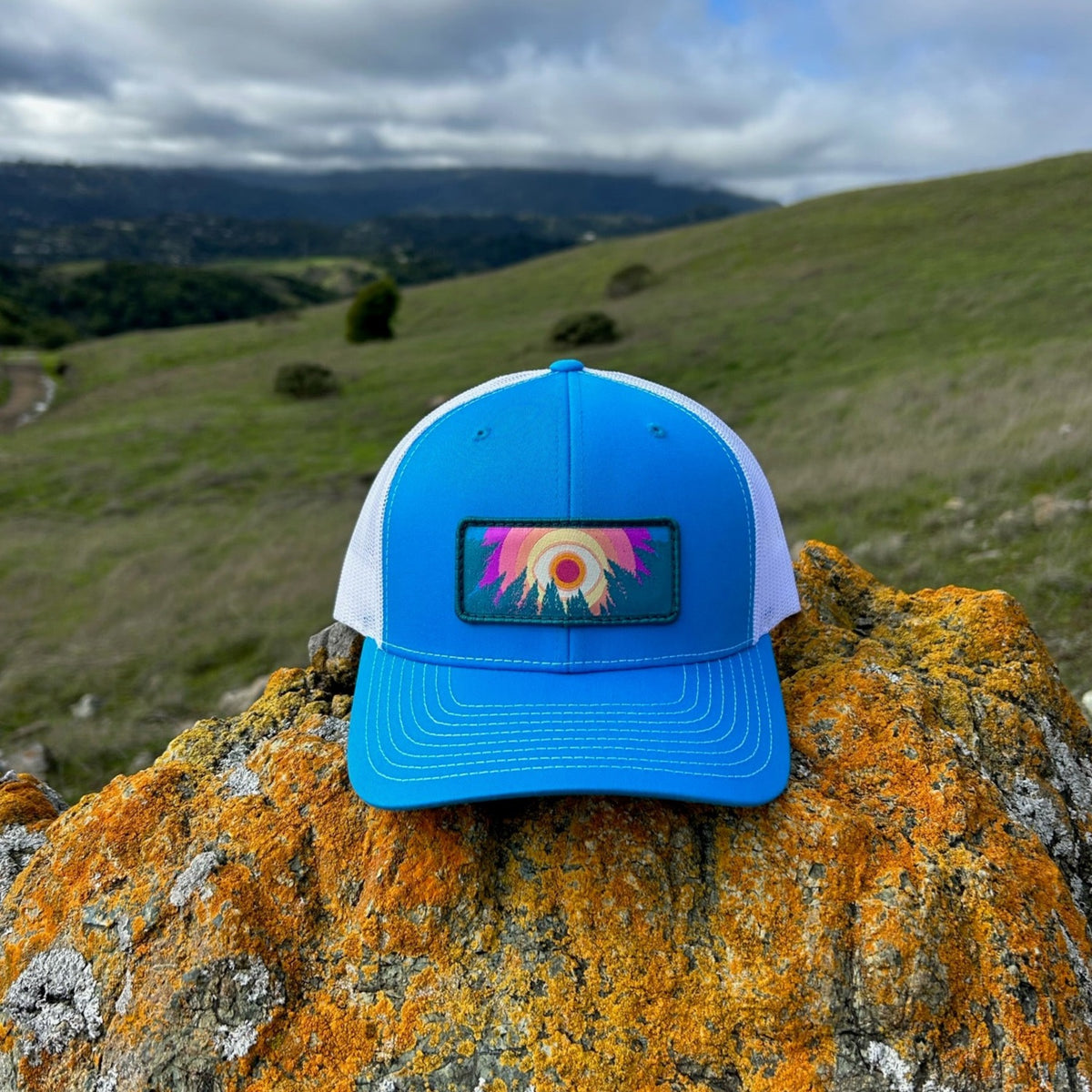 Cyan and white Kooh Culture trucker hat with the In the Trees patch