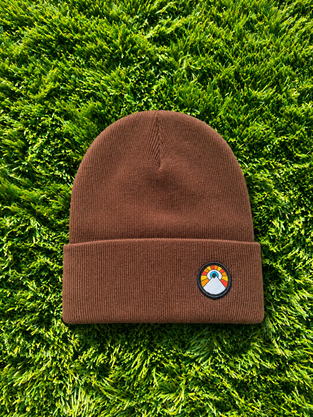 Brown Kooh Culture cuffed beanie with the Evil Eye Sun patch