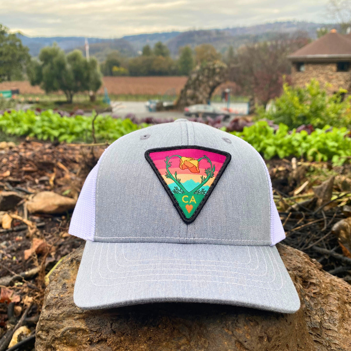 Grey and white Kooh Culture youth trucker hat with the Poppy CA Love patch