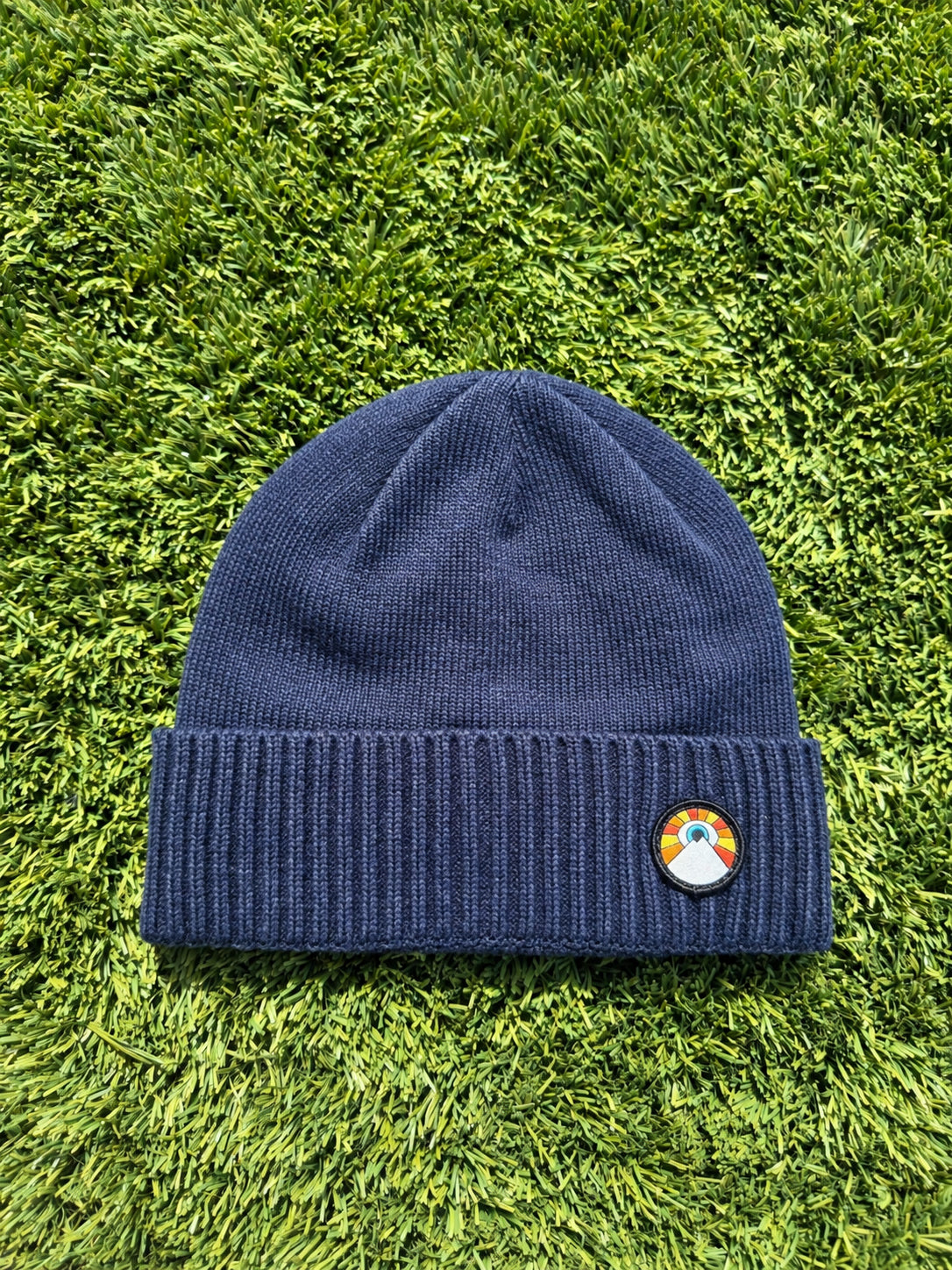 Navy Kooh Culture beanie with a ribbed cuff and the Evil Eye Sun patch