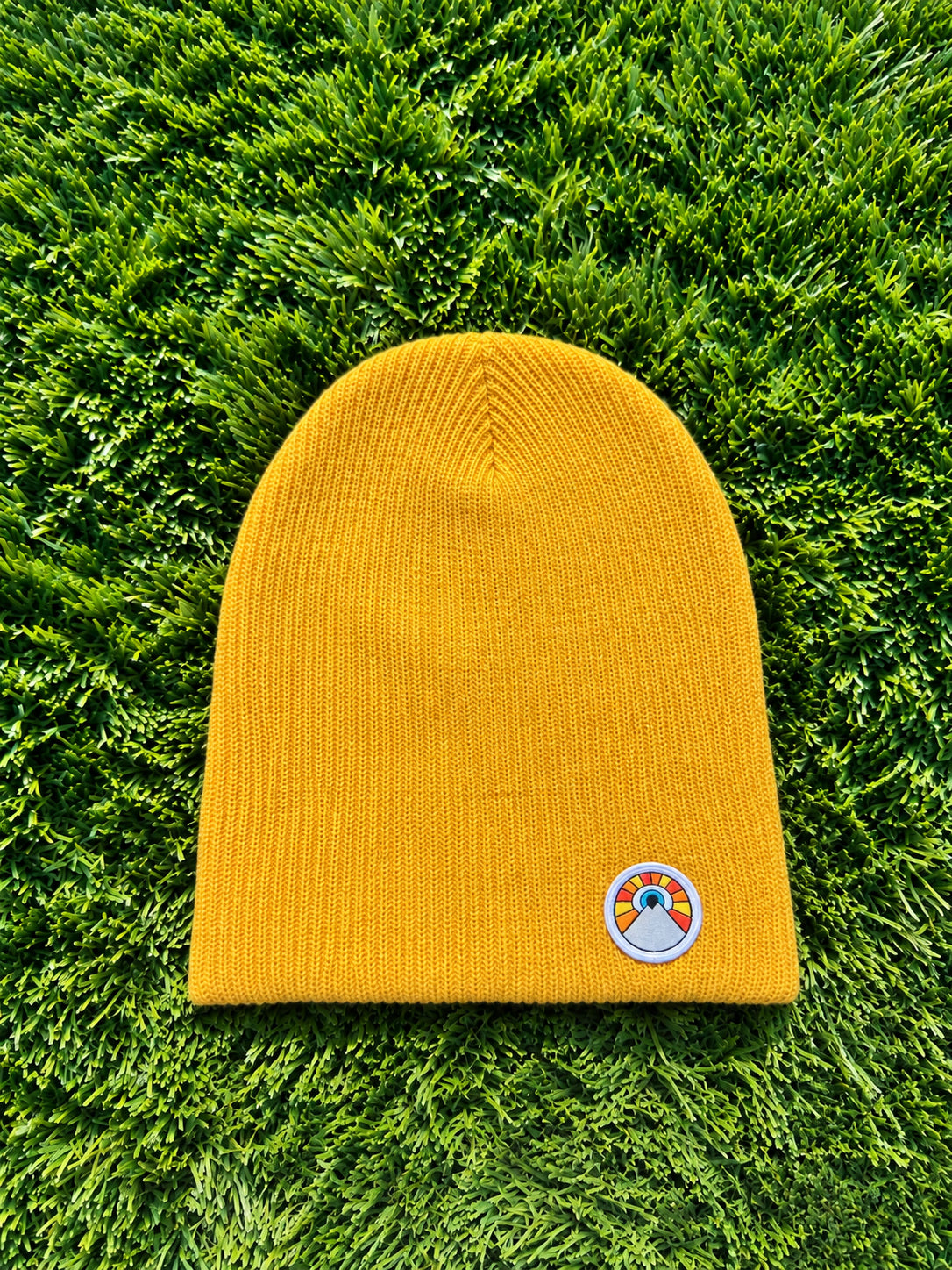Gold Kooh Culture slouchy beanie with the Evil Eye Sun patch