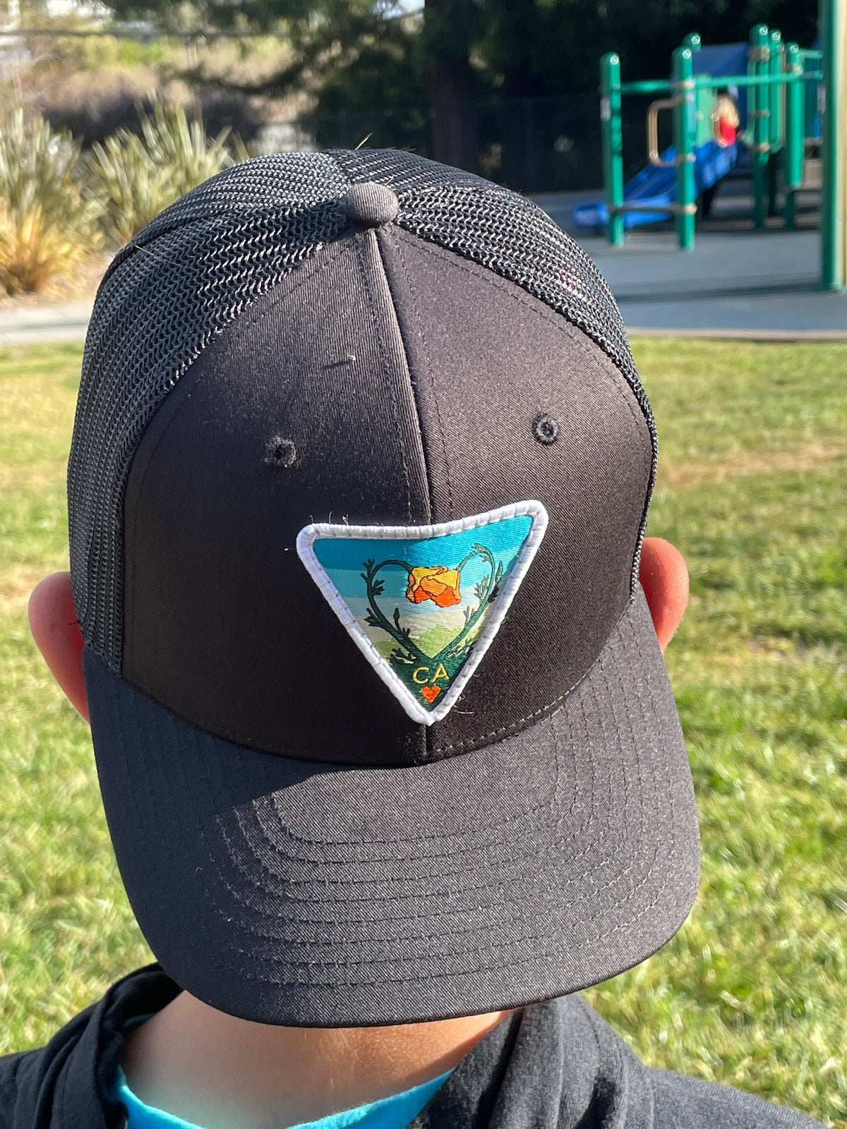 Black Kooh Culture youth trucker hat with the Poppy CA Love patch, alternate view