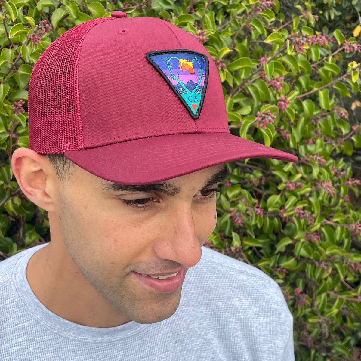 Burgundy Kooh Culture trucker hat with the Poppy CA Love patch in Night Mode colours, alternate view
