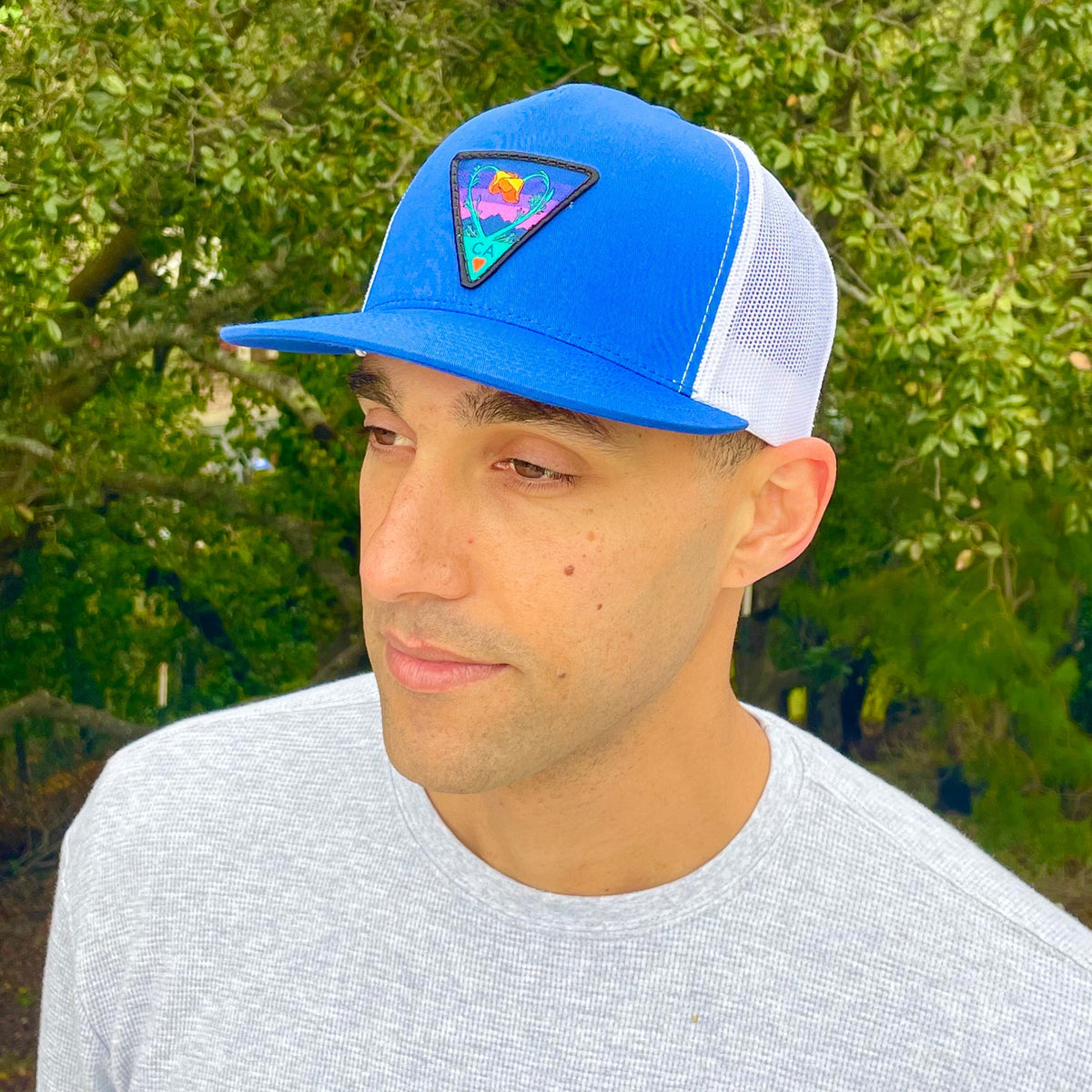Royal and white Kooh Culture flat brim trucker hat with the Poppy CA Love patch in Night Mode colours