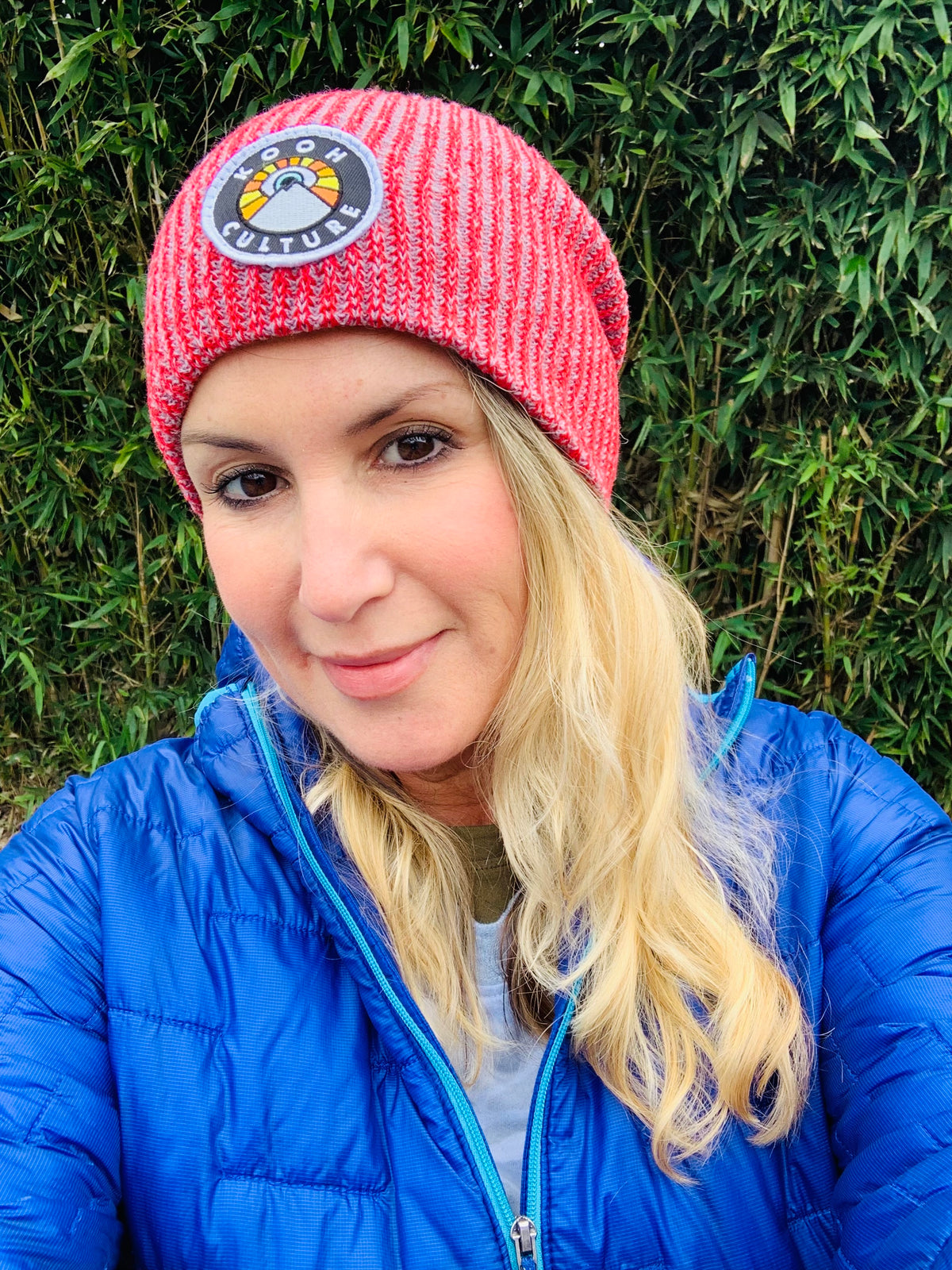 Red and grey Kooh Culture cuffed beanie with the mountain and sun badge, alternate view