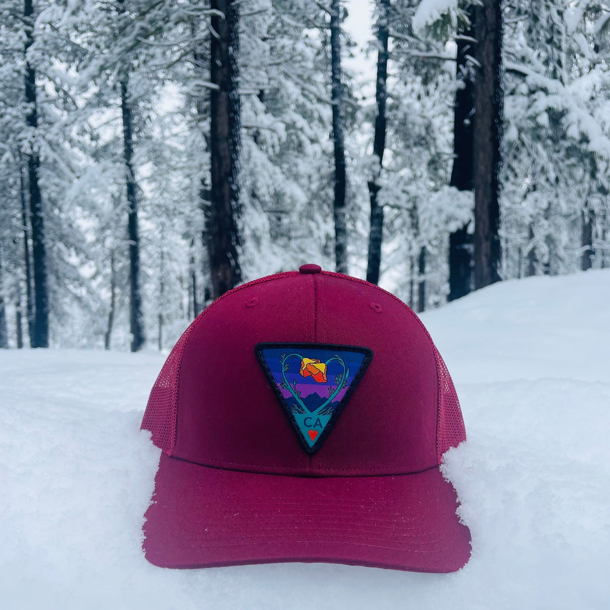 Burgundy Kooh Culture trucker hat with the Poppy CA Love patch in Night Mode colours
