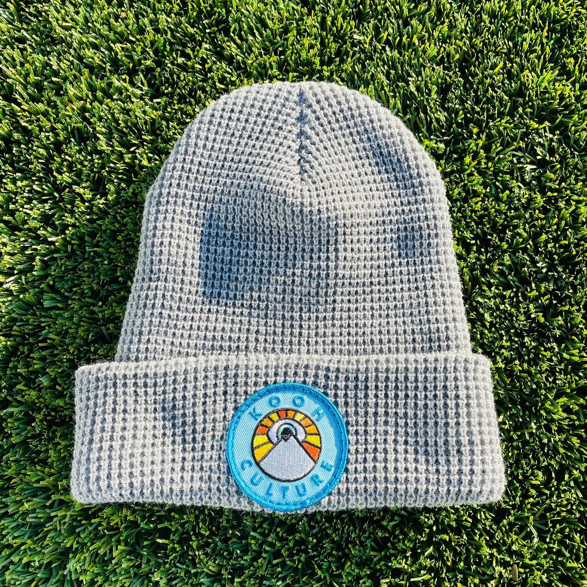 Heather grey Kooh Culture waffle cuff beanie with the mountain and sun badge