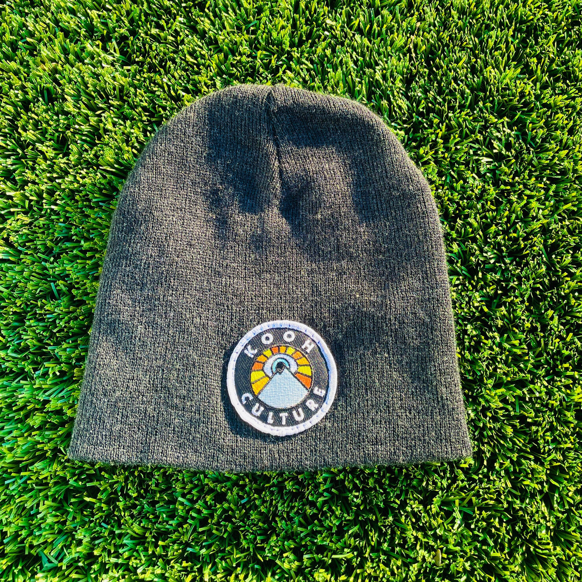 Charcoal Kooh Culture cuffed beanie with the mountain and sun badge